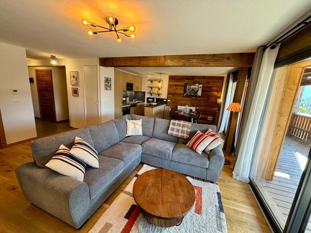 un salon avec un canapé et une table dans l'établissement Grand T4 lumineux en plein coeur de Châtel - Multipass inclu, à Châtel