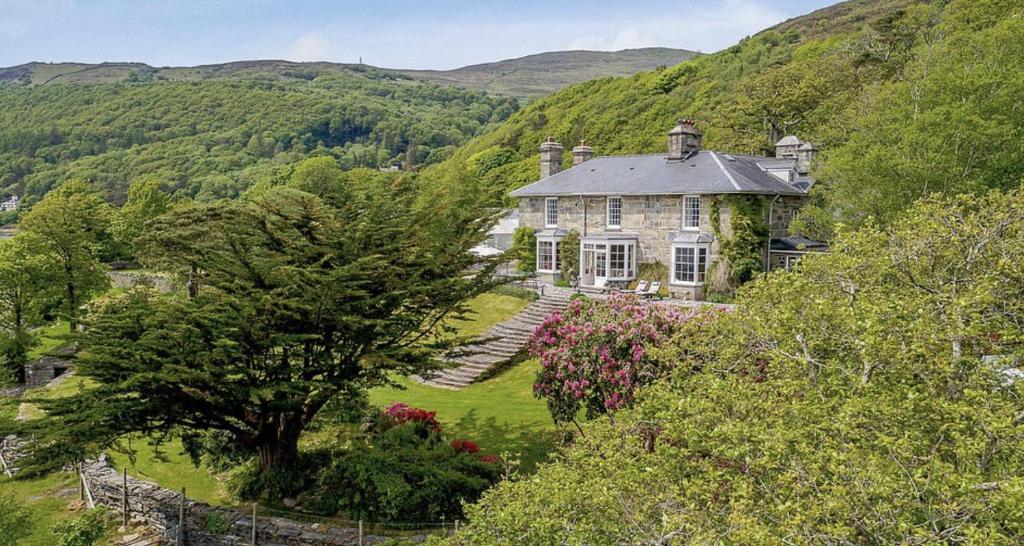 a large house in the middle of a hill at Magnificent Country House with Swimming Pool in Barmouth