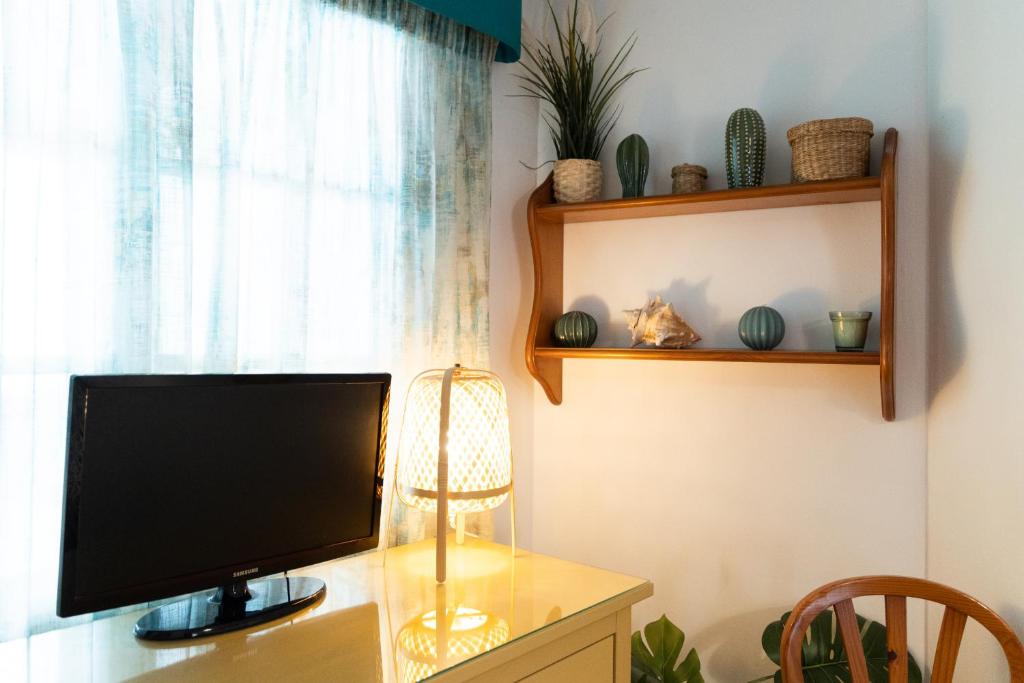 TV a/nebo společenská místnost v ubytování Apartamento Medina
