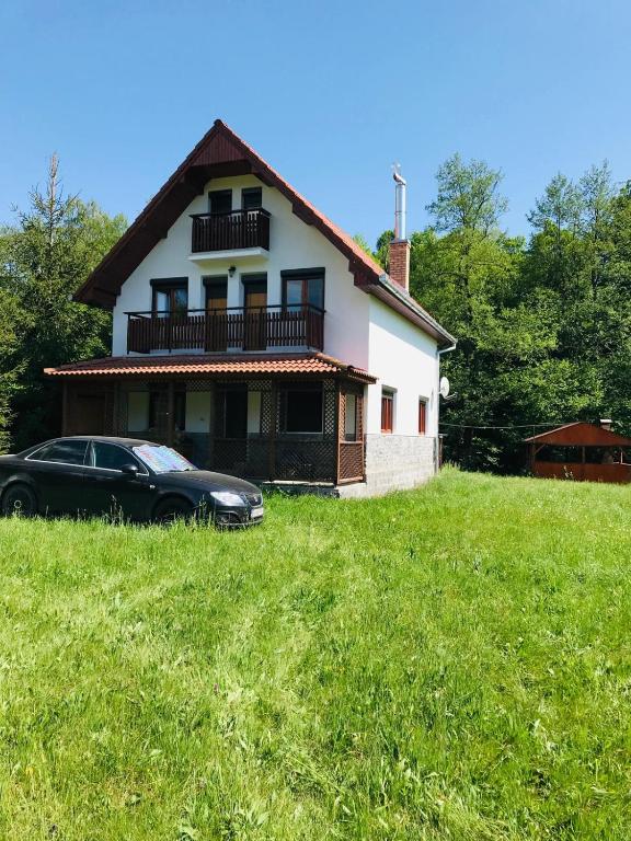 a black car parked in front of a house at ViiLa Cabanuta in Filia