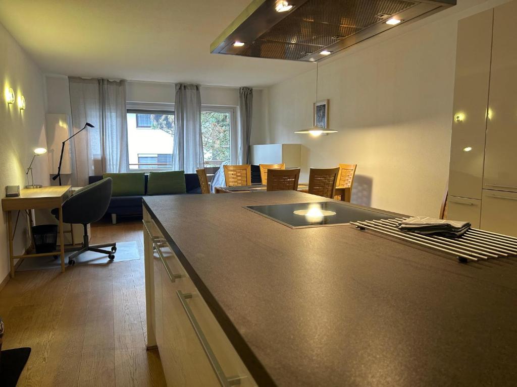 a kitchen and living room with a large counter top at Gipfelblick mit Hallenbad und Sauna in Bergen