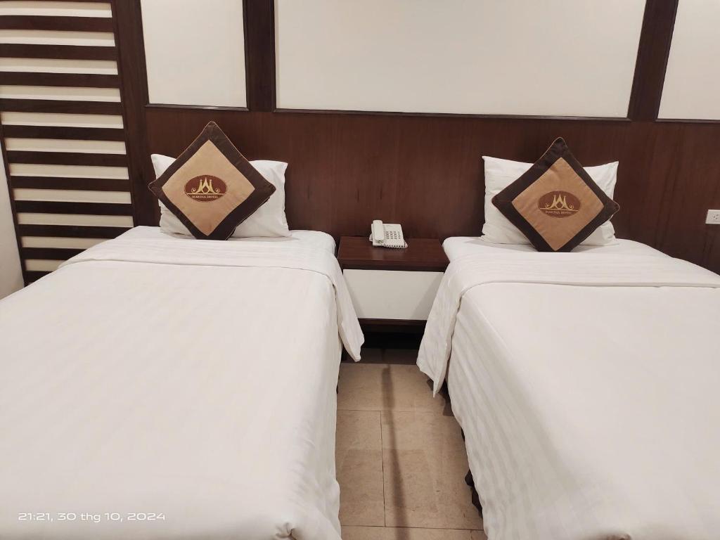 Postel nebo postele na pokoji v ubytování Marina Hotel Ha Noi