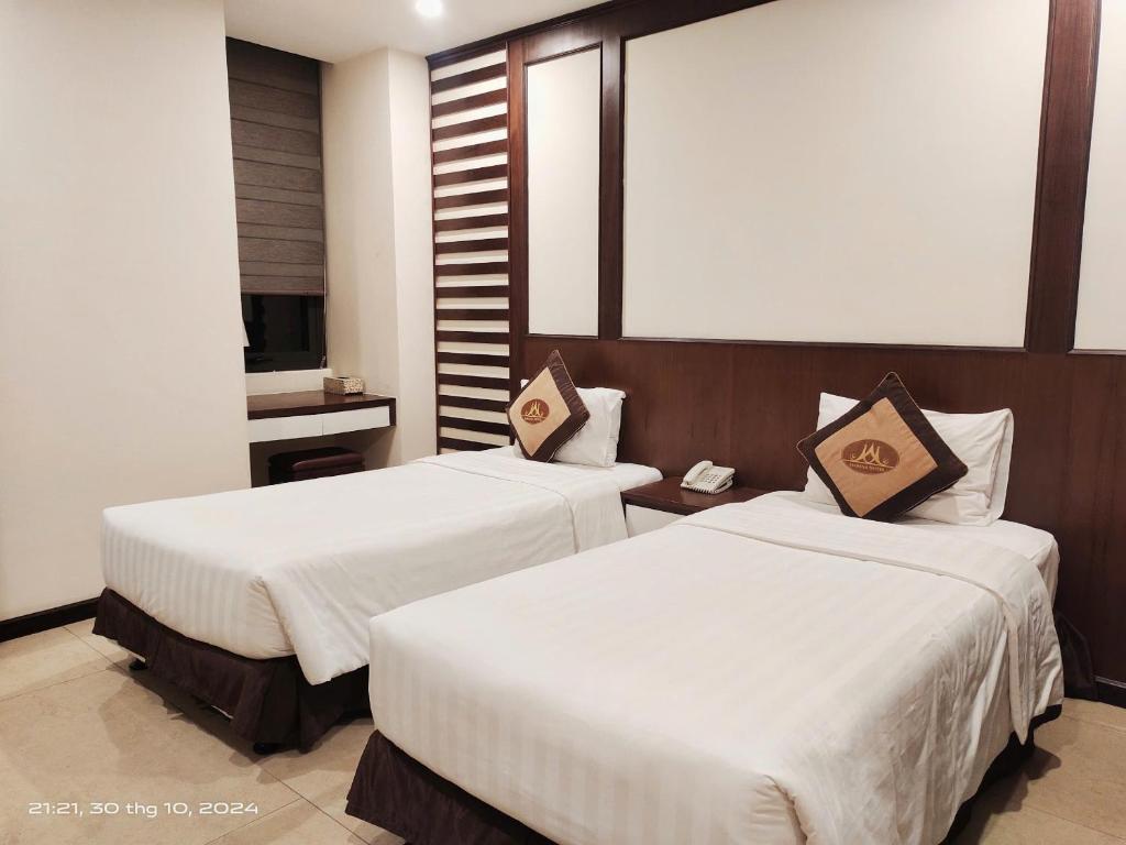 Postel nebo postele na pokoji v ubytování Marina Hotel Ha Noi