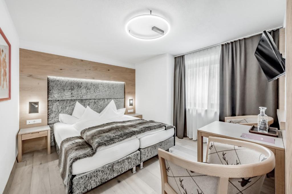 Postel nebo postele na pokoji v ubytování Hotel Grauer Bär
