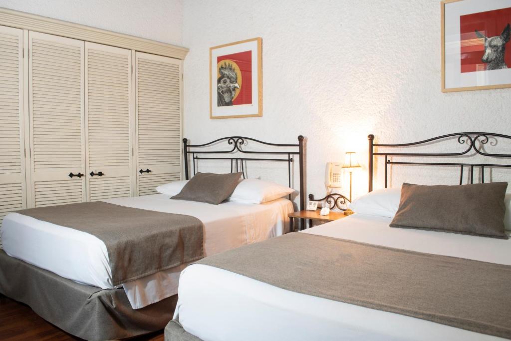 Postel nebo postele na pokoji v ubytování Pórtico Hotel & Galería
