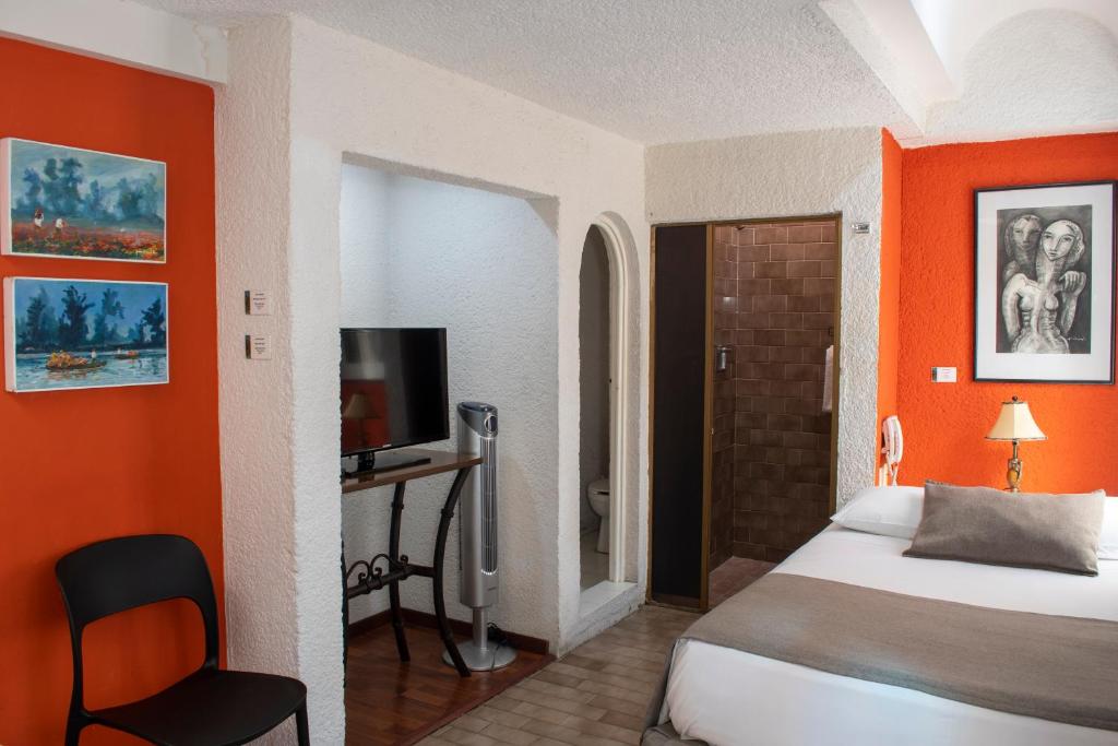 Postel nebo postele na pokoji v ubytování Pórtico Hotel & Galería