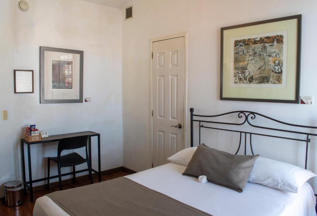 Postel nebo postele na pokoji v ubytování Pórtico Hotel & Galería