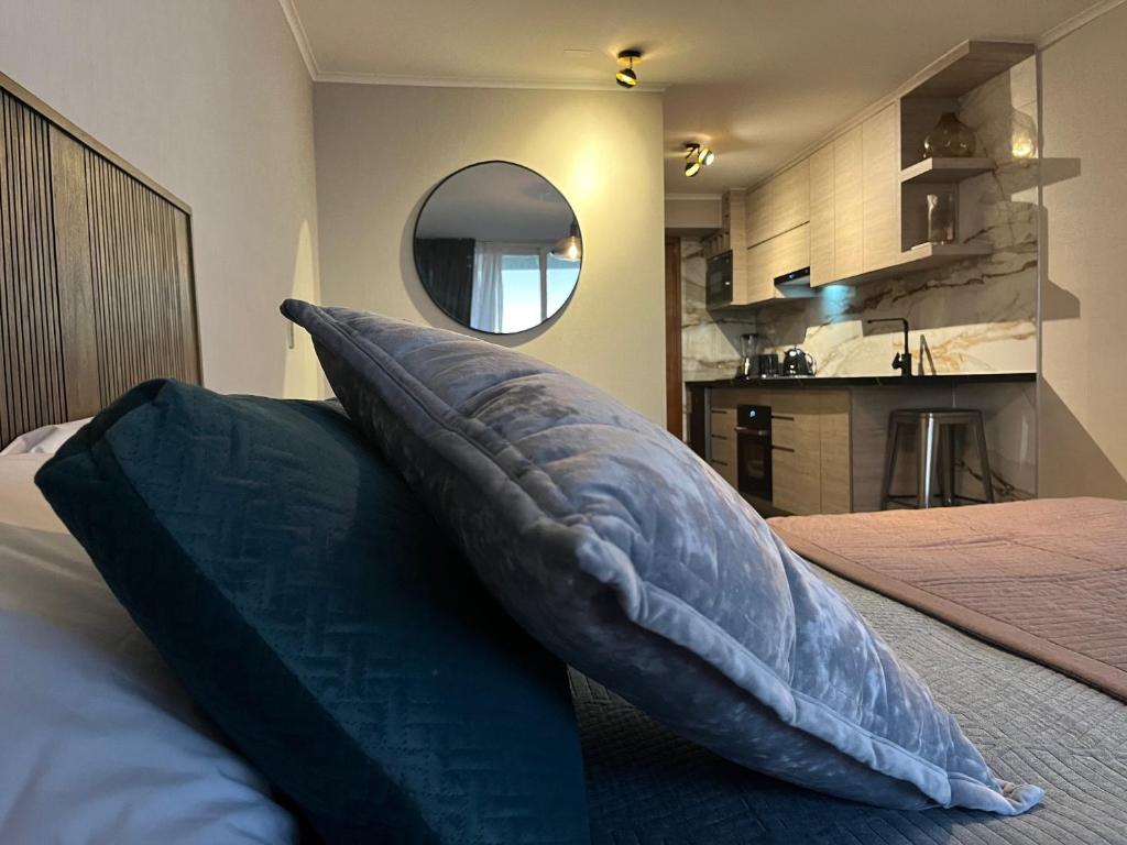 a pillow sitting on a bed in a bedroom at Roca Town House in Viña del Mar