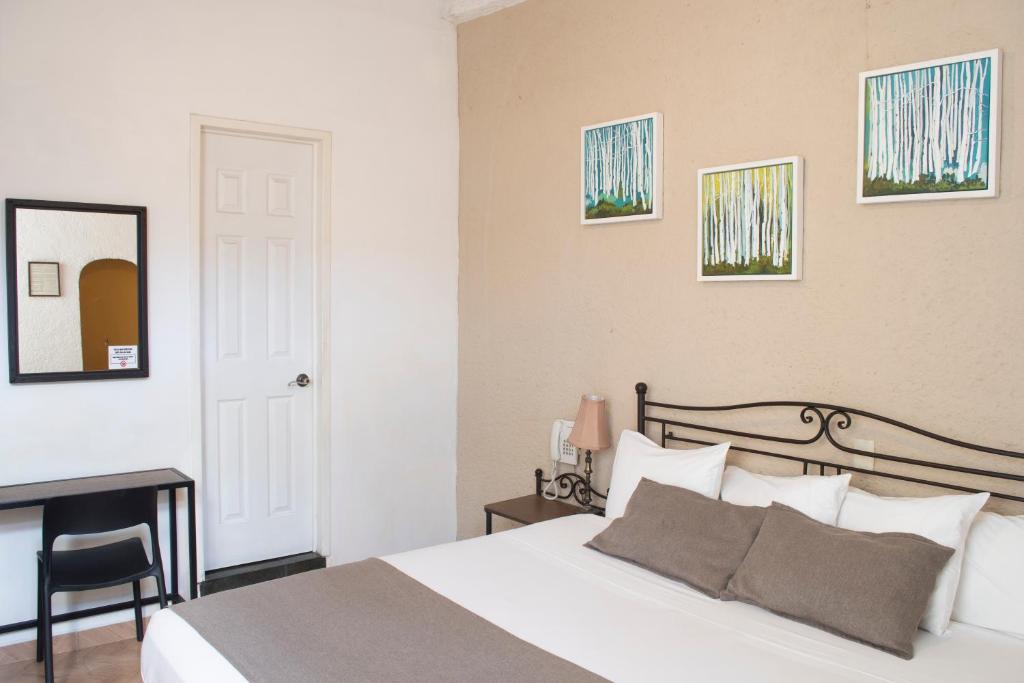 Postel nebo postele na pokoji v ubytování Pórtico Hotel & Galería