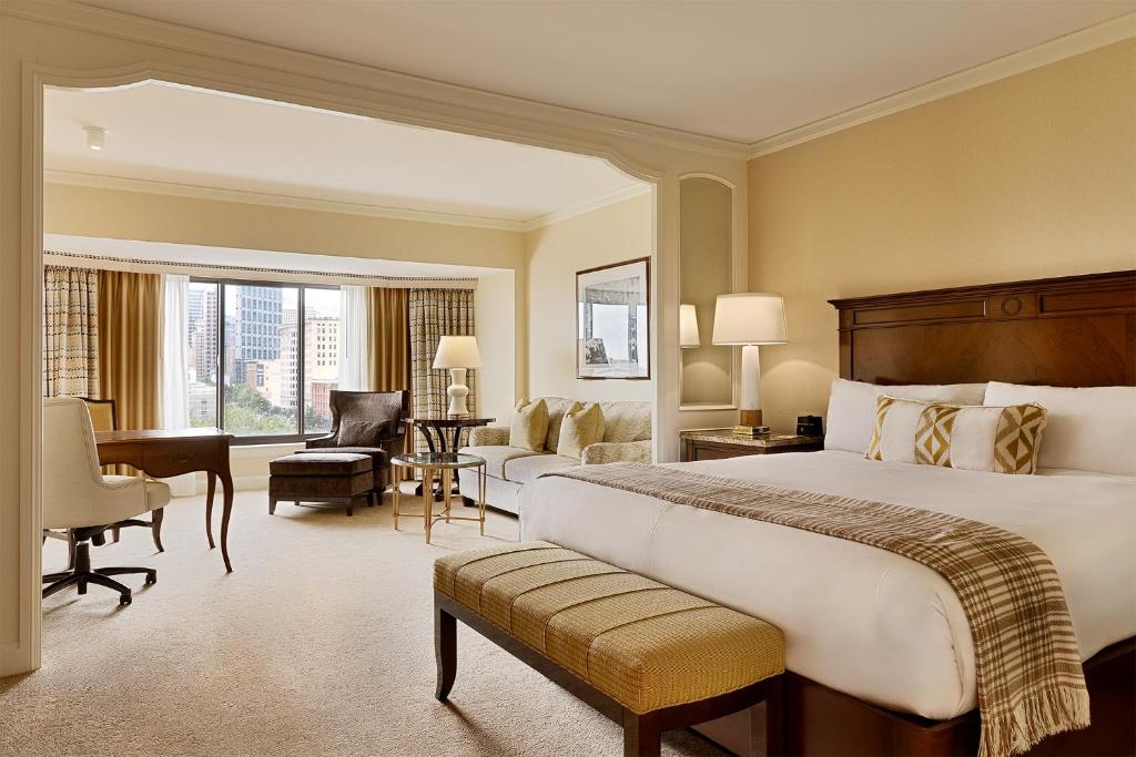 a hotel room with a large bed and a desk at Little America Hotel Salt Lake City in Salt Lake City