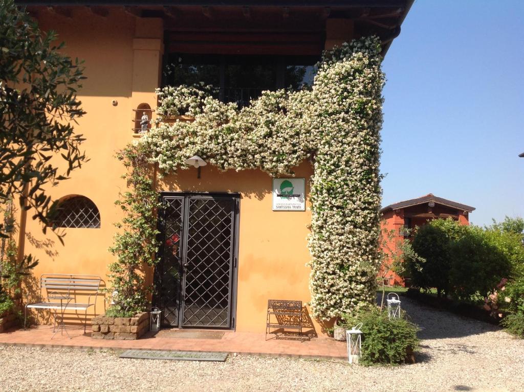 a building with a door covered in flowers at Azienda Agrituristica Santissima Trinità in Budrio