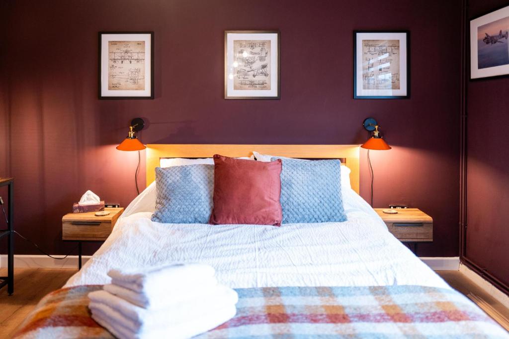 a bedroom with a bed with pillows and two lamps at Family & Pet-Friendly Seaside Bungalow with Accessible Features in Minster
