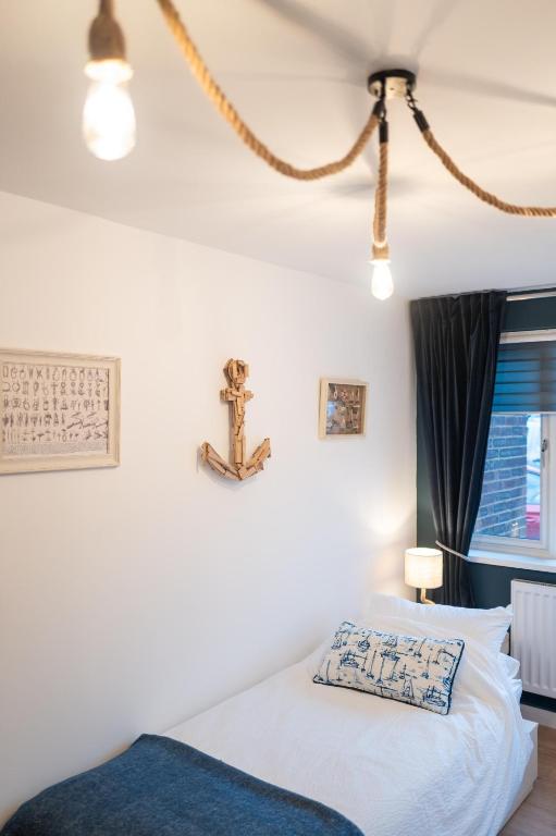 a bedroom with a bed with a cross on the wall at Family & Pet-Friendly Seaside Bungalow with Accessible Features in Minster