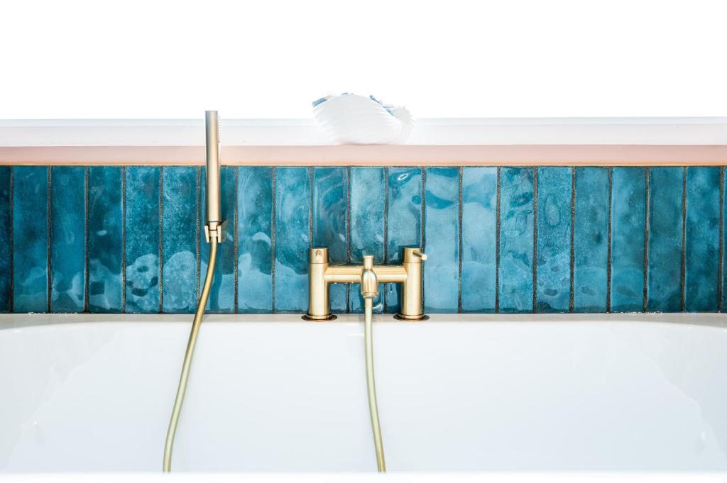 a bathroom with a sink and a faucet at Family & Pet-Friendly Seaside Bungalow with Accessible Features in Minster