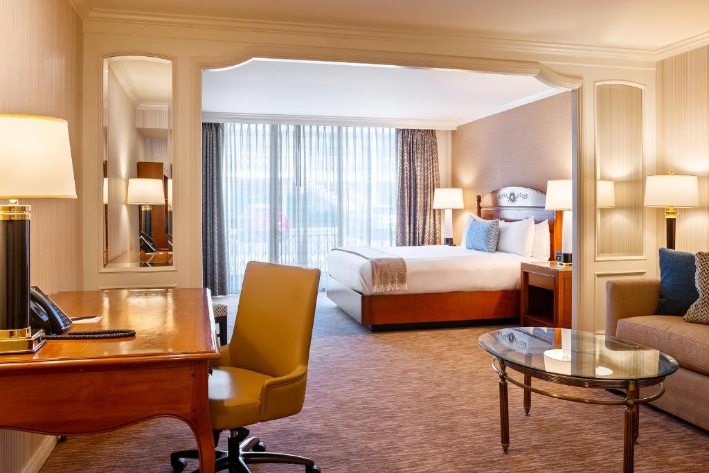 a hotel room with a bed and a desk at Little America Hotel Salt Lake City in Salt Lake City