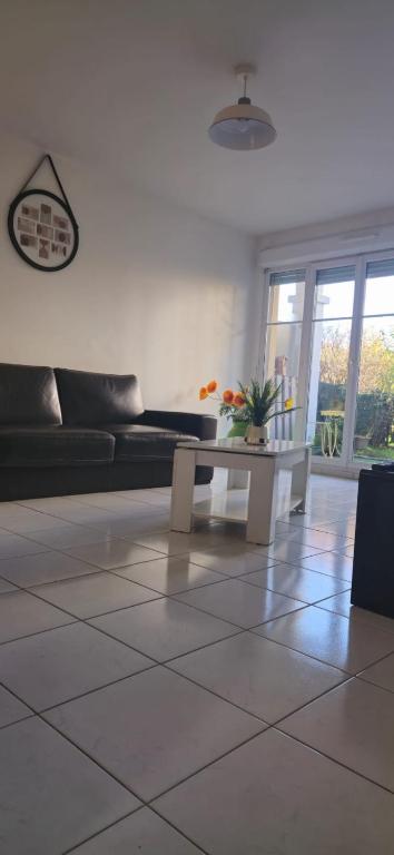 un salon avec un canapé et une table dans l'établissement Lovely & Cosy Appartement à Disneyland, à Montévrain