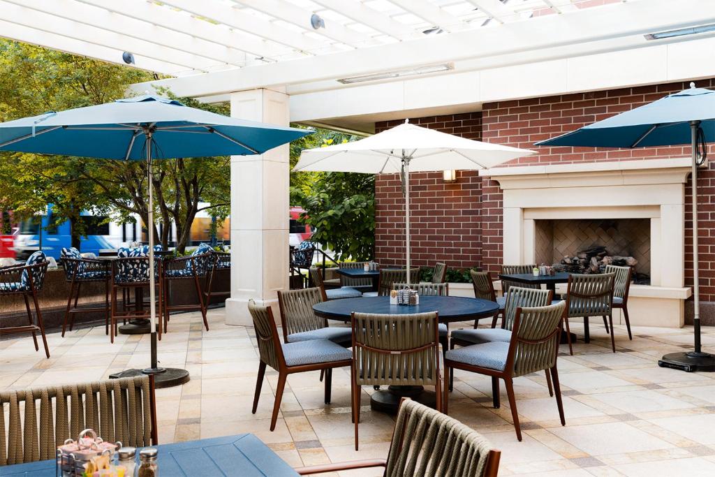 a patio with tables and chairs and a fireplace at Little America Hotel Salt Lake City in Salt Lake City