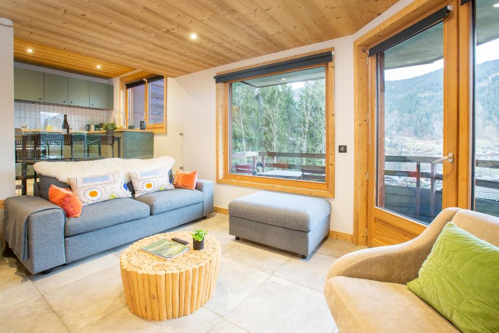 un salon avec deux canapés et une table dans l'établissement Stylish 1 bed apartment with a view to die for!, à Morzine