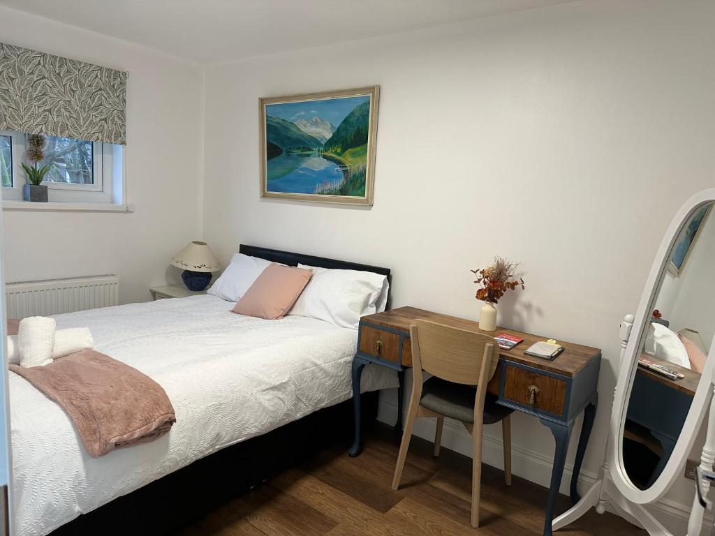 a bedroom with a desk and a bed and a table at SONG House in London