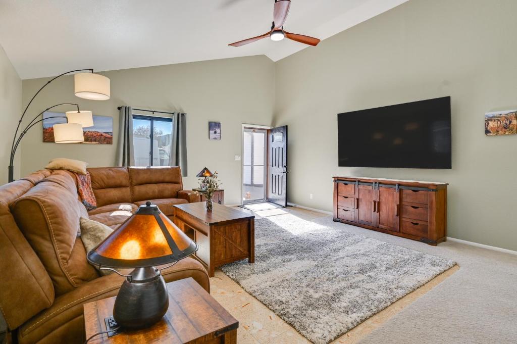 a living room with a couch and a flat screen tv at 3 Mi to The Polar Express Williams Home with Grill! in Williams