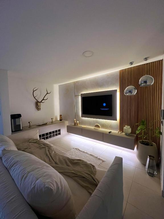 a living room with a flat screen tv on the wall at Apartamento Paris con 2 habitaciones in San Luis