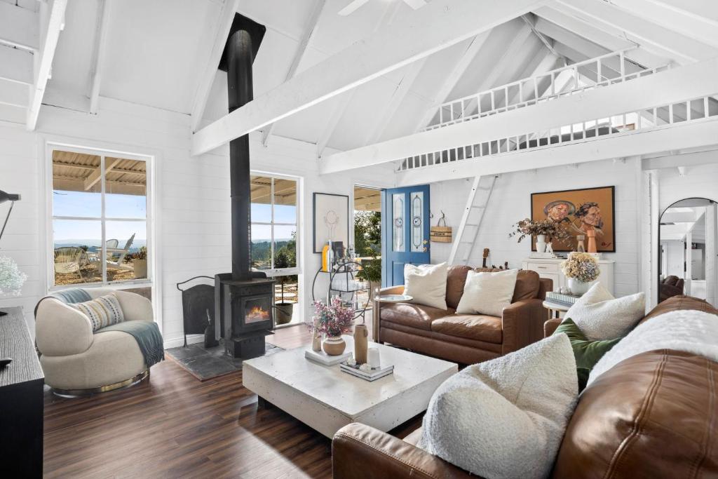 a living room with a couch and a fireplace at Honey Hill in Glenlyon