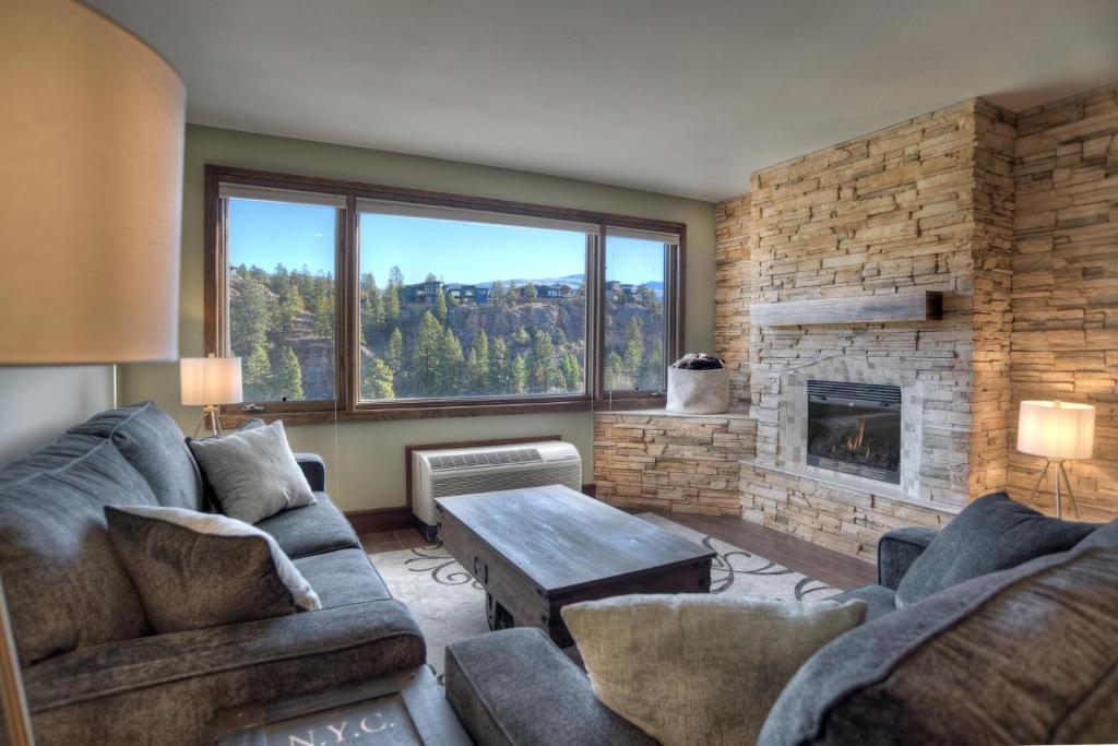 a living room with a couch and a fireplace at Tamarron Lodge Suite 417-416 in Durango