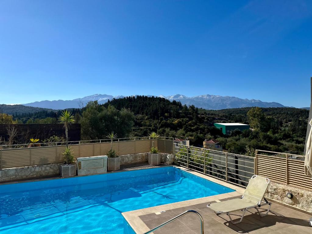 a swimming pool on top of a house at Aegean View Villa, 2-min Drive to Almyrida Beach in Almyrida
