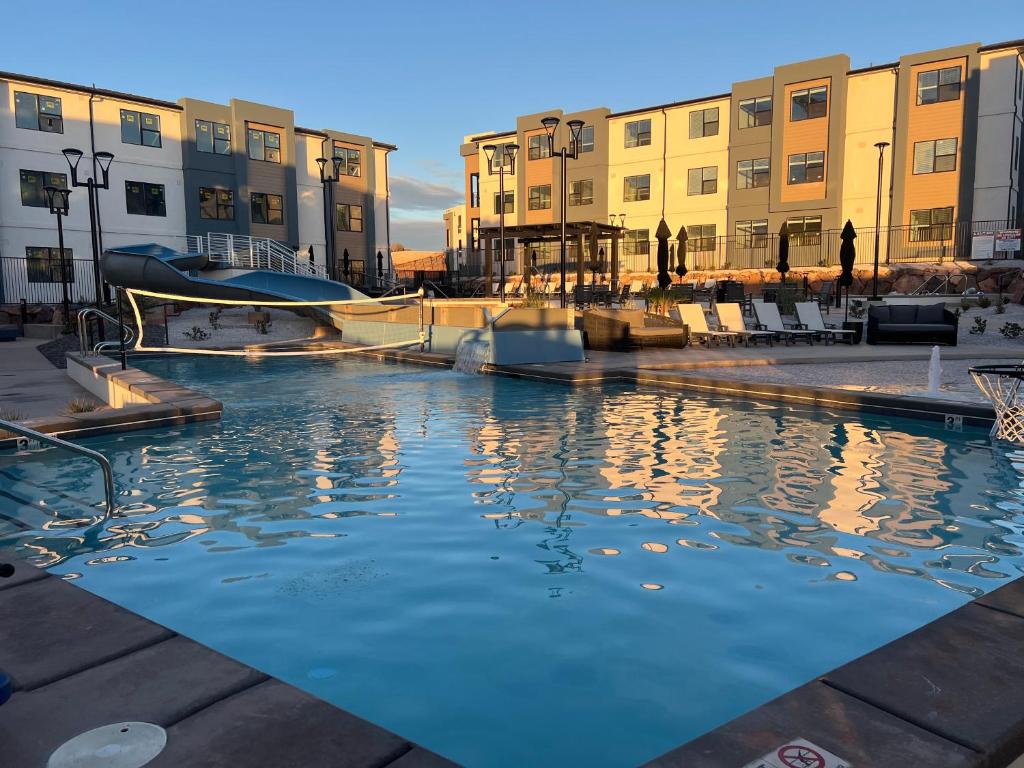 a pool of water with buildings in the background at New Resort Condo Near Zion Great for Families Pools Water Slide in Hurricane