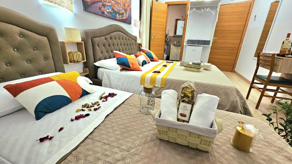 a bedroom with two beds and a table with flowers on it at Luxury A Casa Simpatia Roma - If you book a minimum of 5 nights breakfast is included in Rome