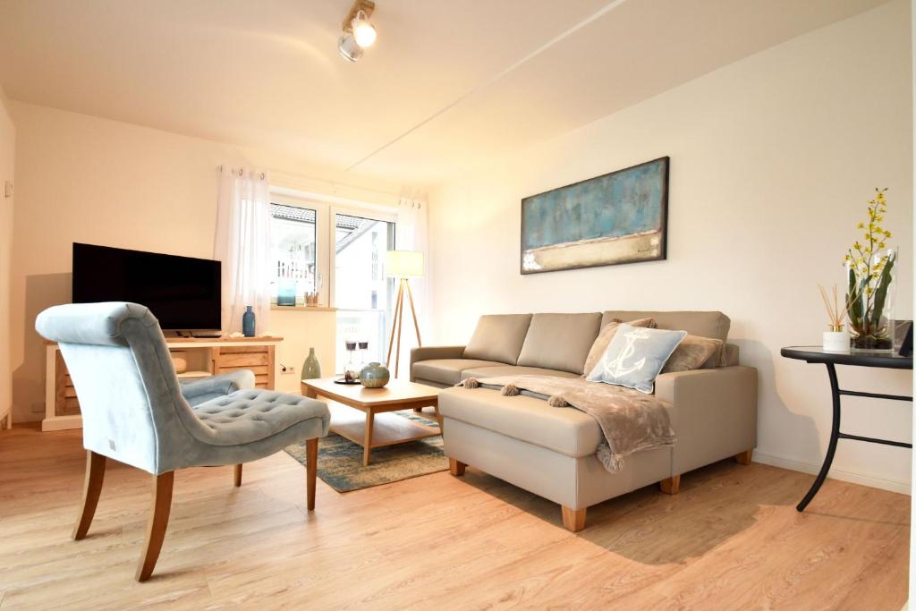 a living room with a couch and a chair at Ferienwohnung Traumdüne im Ostseebad Baabe in Baabe