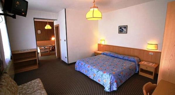 Postel nebo postele na pokoji v ubytování Hotel Miramonti