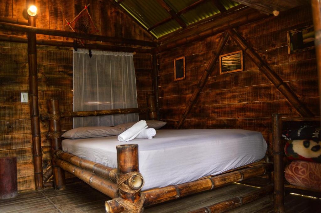 Postel nebo postele na pokoji v ubytování Cabañas Rusticas El Viejo Tambo