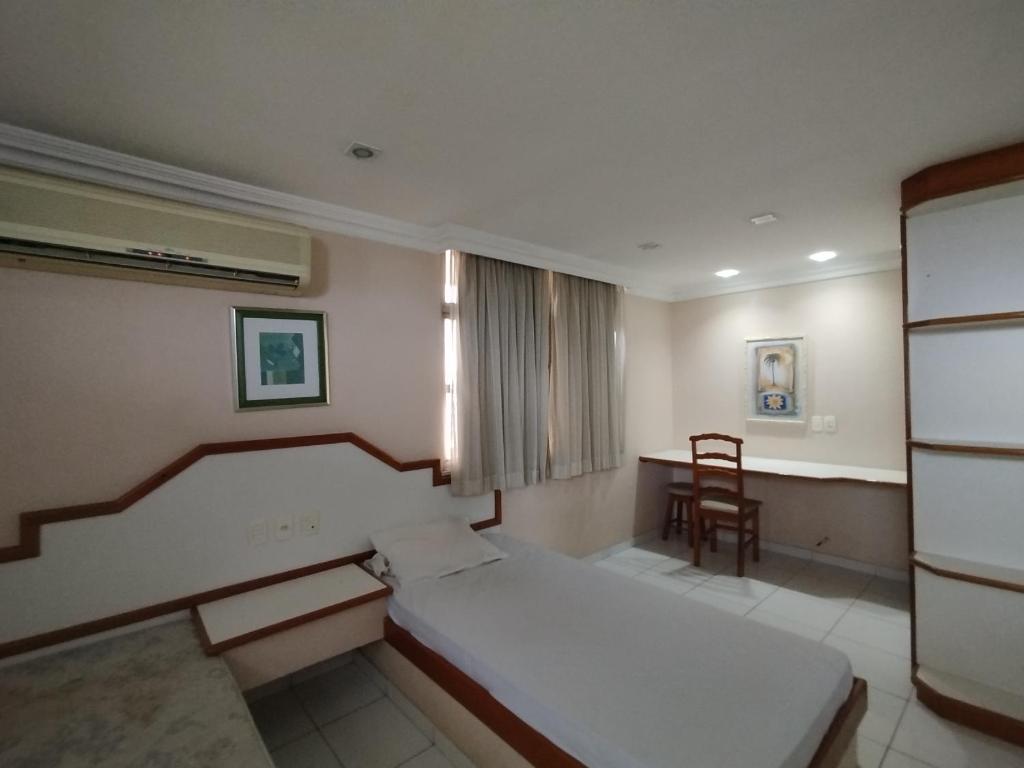 a hospital room with a bed and a chair at Slaass flat in Manaus