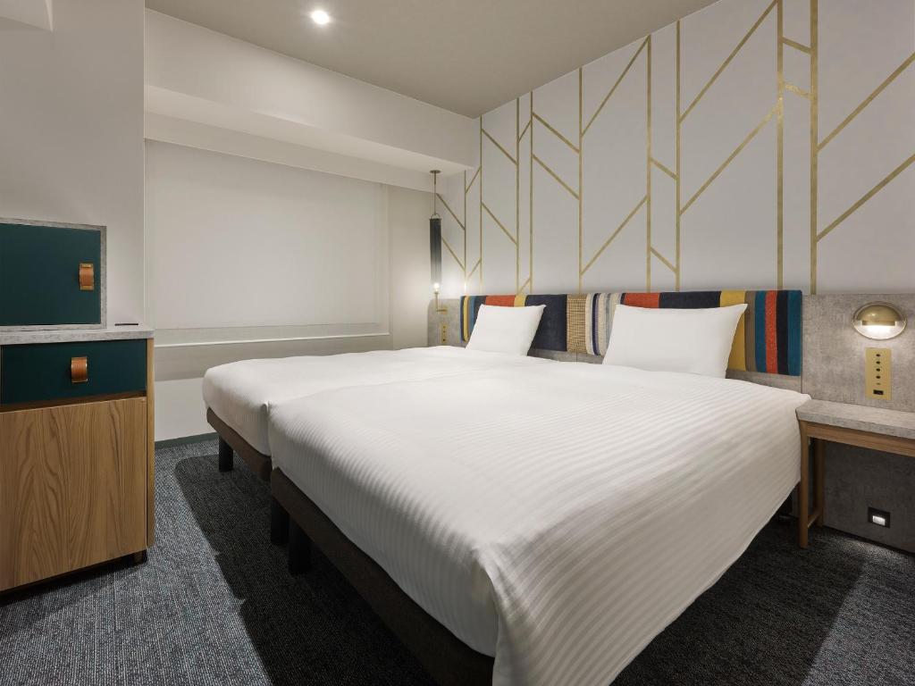 Postel nebo postele na pokoji v ubytování Mitsui Garden Hotel Ueno