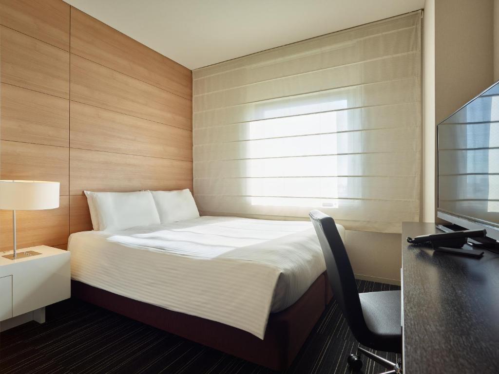 Postel nebo postele na pokoji v ubytování Mitsui Garden Hotel Ueno