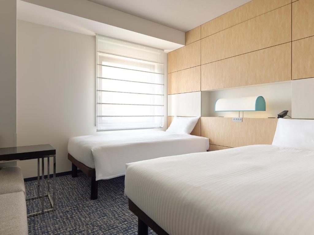 Postel nebo postele na pokoji v ubytování Mitsui Garden Hotel Ueno