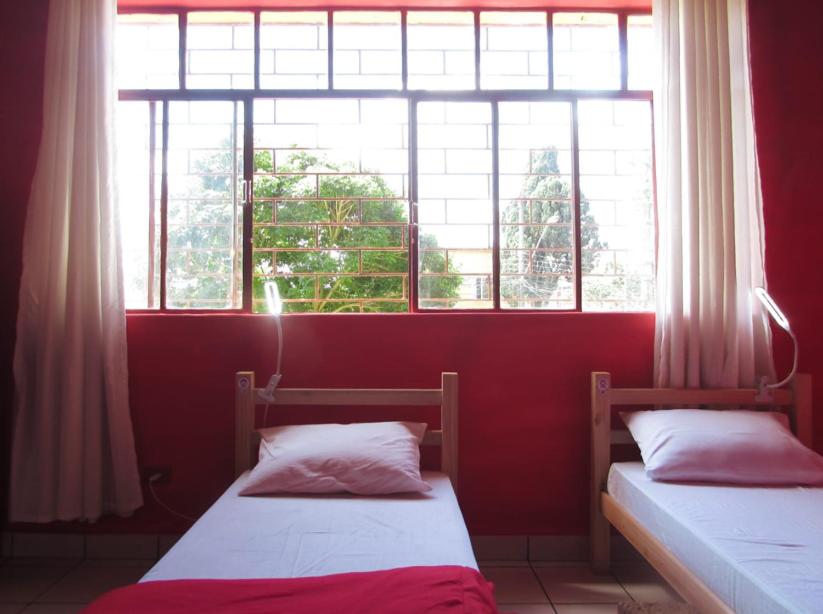 Postel nebo postele na pokoji v ubytování Hostel Kaizen Curitiba