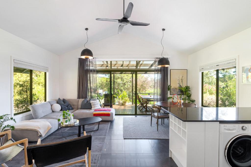 a living room with a couch and a table at Mike's - A Luxurious Cabin Surrounded By Nature in Kangaroo Valley