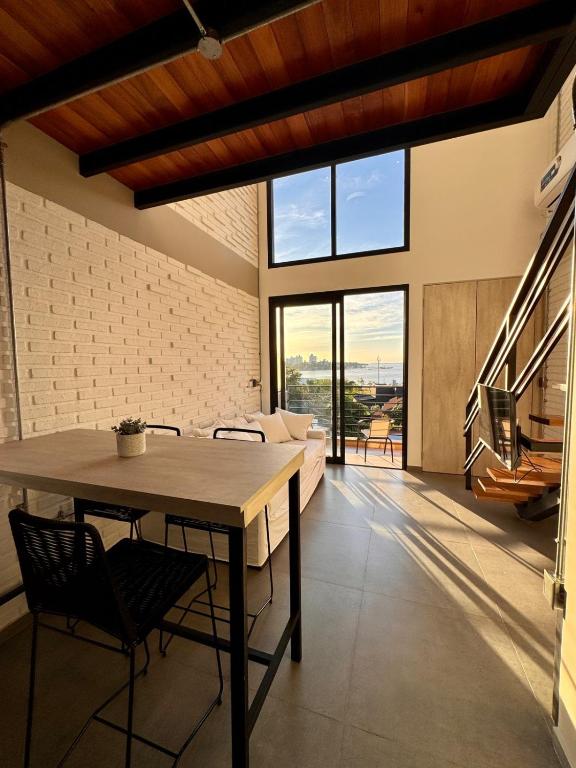 a dining room with a table and some chairs at DPTO 405 Edif Loftier in Posadas