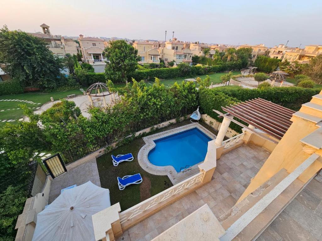 an aerial view of a backyard with a swimming pool at Standalone Villa in New Cairo, Private swimming pool and modern furniture in Cairo