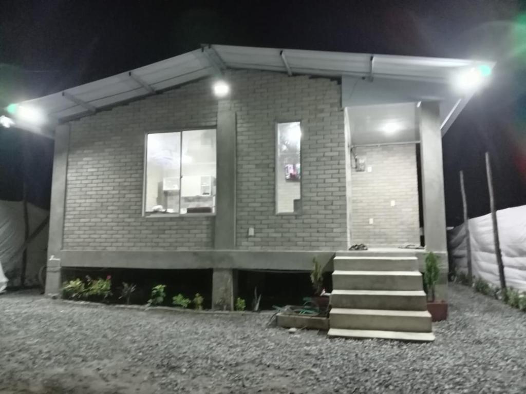 a brick house with stairs in front of it at night at El Rincón de Charito in Tumaco