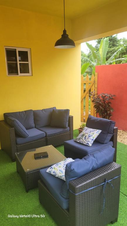 a living room with a couch and a coffee table at Tropical Paradise villa 1 in Ocho Rios