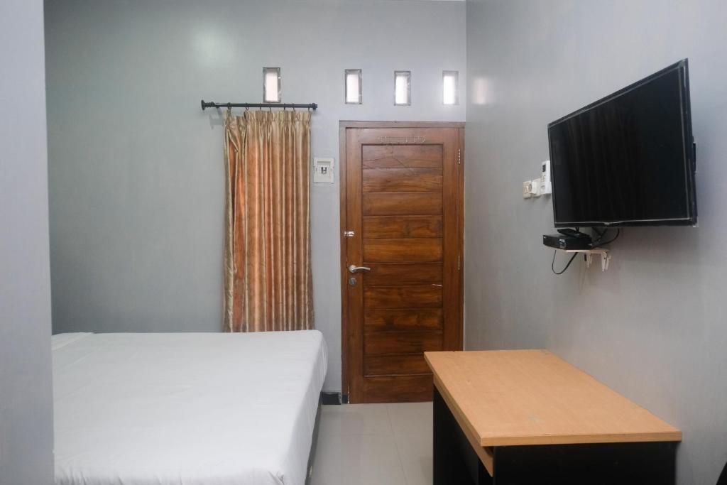 Postel nebo postele na pokoji v ubytování Al Abror Homestay Mandala Krida Mitra RedDoorz