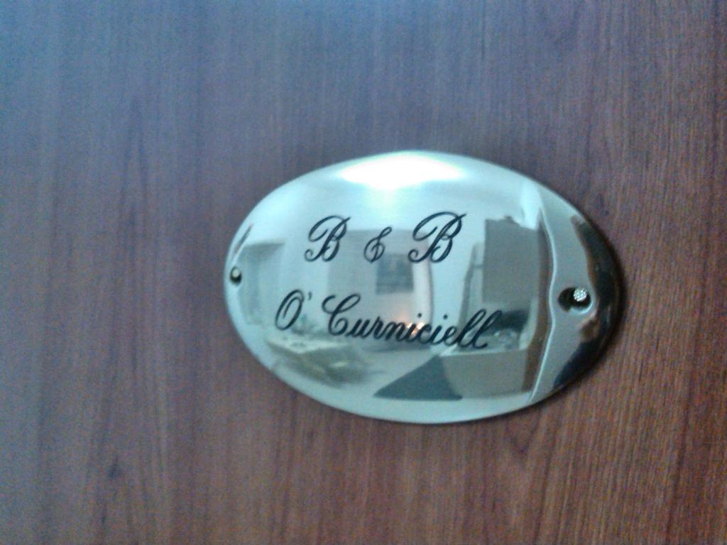 a metal button with the words fidelity of a community at Ocurniciell B&B in Naples