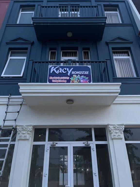 a blue building with a sign on it at Kacy Homestay, Wonderland Hồ Tràm miễn phí vé MUSEUM in Xuyên Mộc