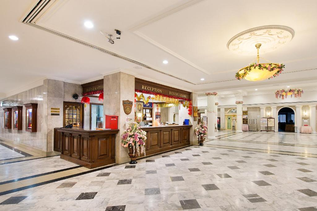 A large marble-floored lobby with a wood-paneled reception desk.