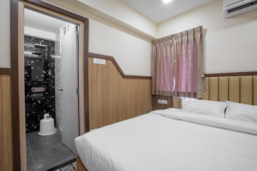 Postel nebo postele na pokoji v ubytování Hotel PRM Aruna Archadia
