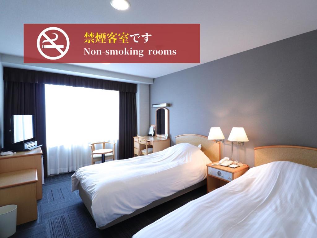 Postel nebo postele na pokoji v ubytování Silk Hotel Annex
