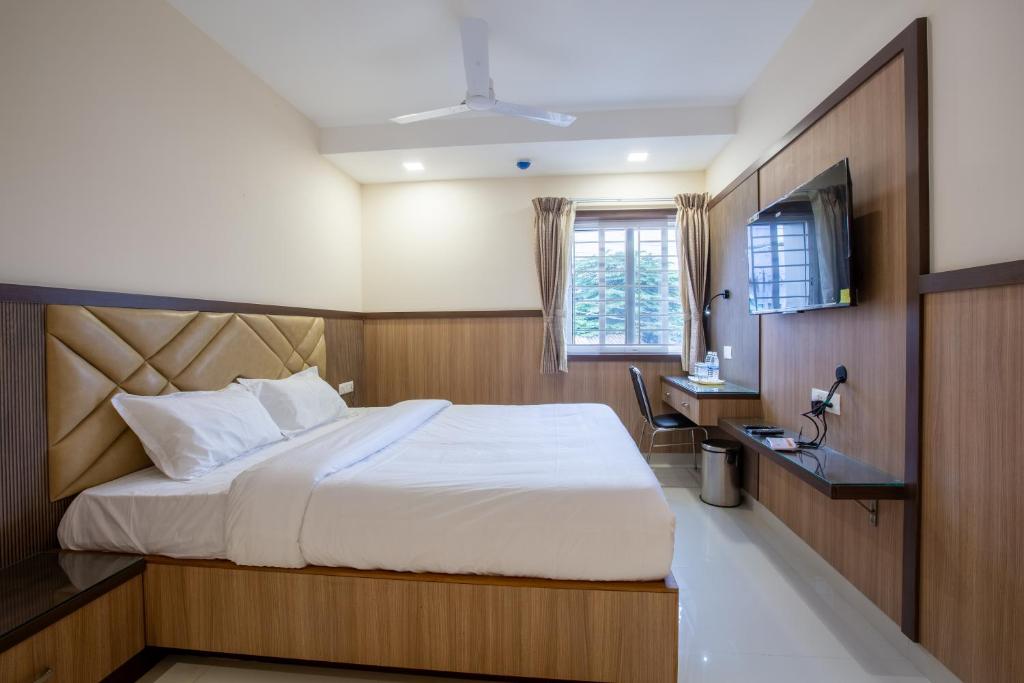 Postel nebo postele na pokoji v ubytování Hotel PRM Aruna Archadia